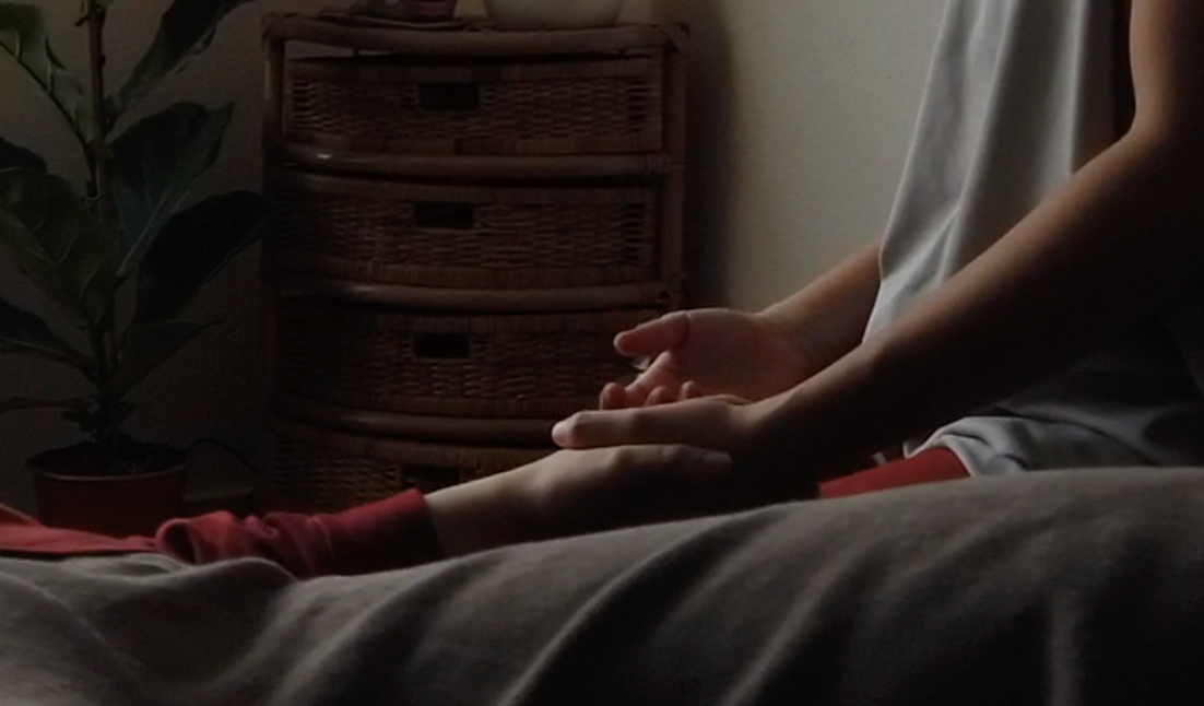 Participants massaging each other in pairs during a group class